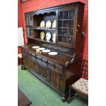 A large modern Miss Tudor oak dresser, supplied by Iron Gate Furnishings, Derby, stepped cornice,
