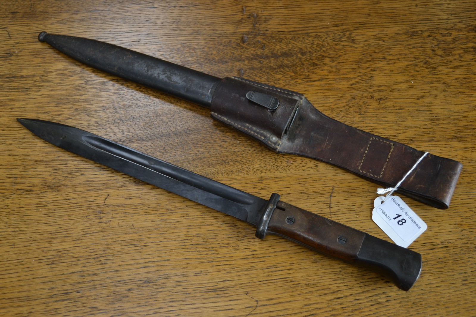 A German bayonet and scabbard with leather frog,