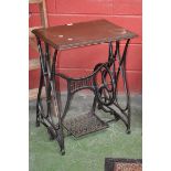 A cast iron Bradbury treadle sewing machine base converted to a table.