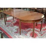 A George III mahogany D-end extending dining table.
