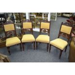 A set of four Edwardian mahogany dining chairs, curved top rail, padded back and seat,