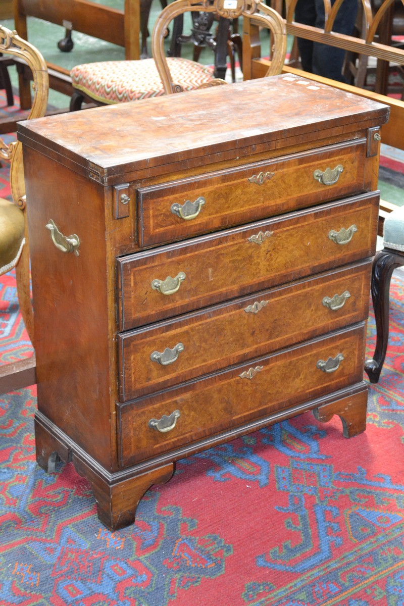 A mahogany and walnut bachelors writing chest, crossbanded quarter veneered fold over top,