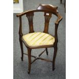 An Edwardian mahogany corner chair, arched arm rail, pierced vasular splat, padded seat,