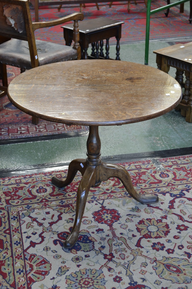 A George III oak birdcage tripod table, circular top, baluster turned column, cabriole legs,