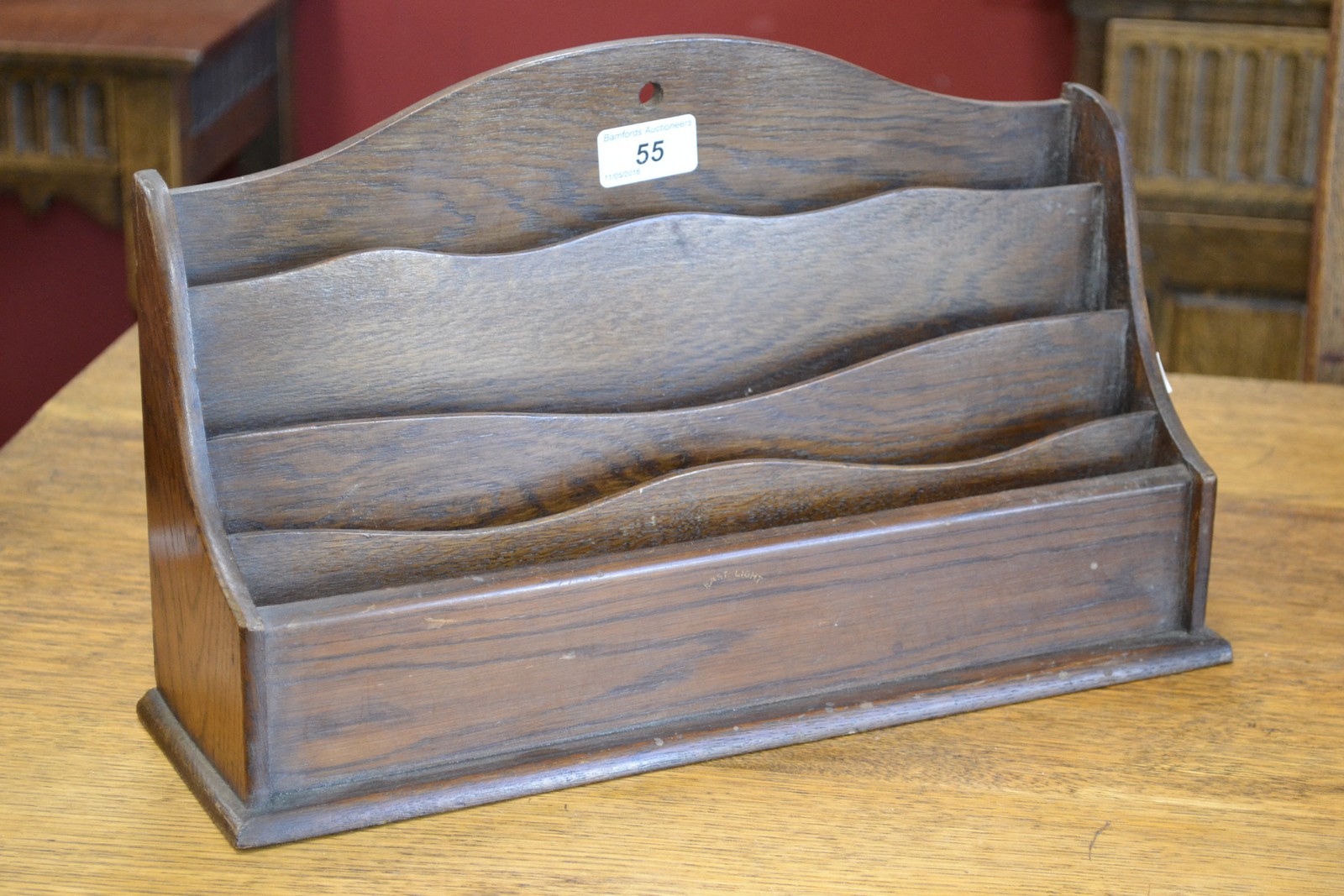 A regimental oak three tier letter rack, transfer applied,