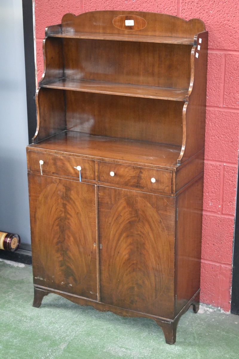 A 19th century mahogany waterfall bookcase cabinet, shaped gallery with flame mahogany cartouche.