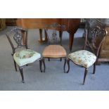 A harlequin set of three Victorian mahogany salon chairs, carved and pierced splats,