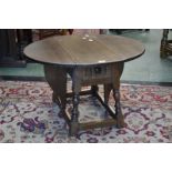 An oak Rupert Griffith drop leaf occasional table, oval top, turned supports.