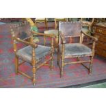 A pair of 17th century style oak armchairs, brass studded tan hide upholstery, c.