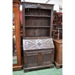 A George III bureau bookcase later top carved in the Jacobean taste, adjustable shelving to top,