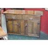 An oak Rupert Griffith oak sideboard, two fluted front drawers over two panelled door cupboard.