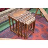 An Art Deco style chip carved nest of four tables,