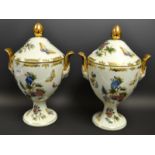 A pair of continental two handled urn shaped vases with covers decorated with peonies and