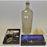 A substantial glass poison bottle; A Bausch & Lomb optical instrument;