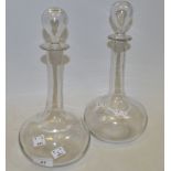 A pair of Victorian glass globe and shaft decanters