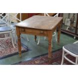 A scrub top pine kitchen table, plank top, single drawer to frieze, button handles, turned supports.