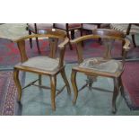 A pair of Arts and Crafts oak smokers bow chairs (2)