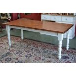 A large painted pine kitchen table, plank top, turned supports. 77cm high x 198cm x 87cm.