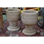 Garden ornaments - a pair of reconstituted stone planters on stands.