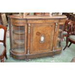 A Victorian walnut breakfront credenza, oversailing top, rounded angles,