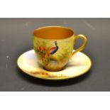 A Royal Worcester coffee can and saucer, signed W H Austen, painted with peacocks,