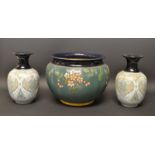 A Langley ware jardiniere; a pair of vases, similar,