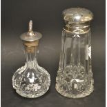 A cut glass oil bottle with silver stopper,