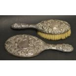 A silver mirror and hairbrush, bearing armorial,