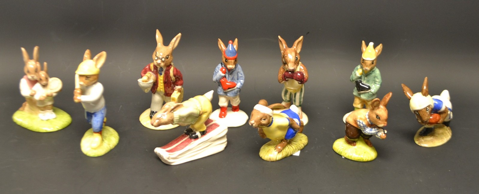 A Royal Doulton Bunnykins Fisherman, boxed; other, Boy Skater, Knockout, Tennis, Downhill, Home Run,