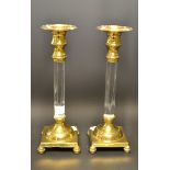 A pair of modern glass candlesticks with brass fittings.