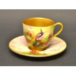 A Royal Worcester coffee can and saucer, signed R Austen, painted with peacocks,