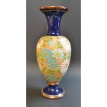 A Doulton Lambeth vase, decorated with flowers on a gold ground,
