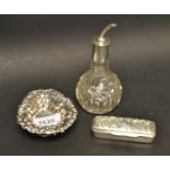 A silver pierced heart shaped dish; an oil bottle with a silver top;