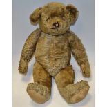 An early 20th century blonde mohair bear, shaved snout, small ears, hump back,long arms, felt pads,