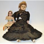 A late 19th century wax head and shoulder doll, blond wig, with fixed blue eyes, wax legs and arms,