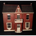 A late 19th century two storey dolls house, twin front doors, flanking a central fixed porch,