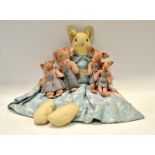 A set of four mid 20th century graduated felt pigs, each standing wearing blue pinafore dresses,