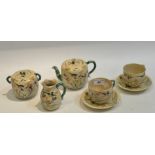 A Japanese Satsuma part tea service, comprising teapot, sugar bowl,