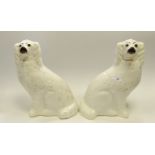 A pair of late 19th Century Staffordshire dogs, seated to the left and right,