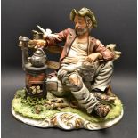 A Capodimonte figure of a contented vagrant, seated on a bench by a stove,