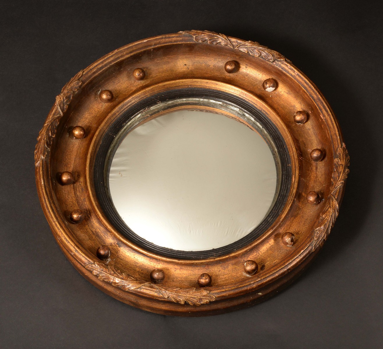 A 19th century circular giltwood and gesso convex looking glass,