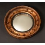 A 19th century circular giltwood and gesso convex looking glass,