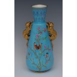 A Derby Crown Porcelain vase, decorated with butterflies and foliage on a turquoise ground,