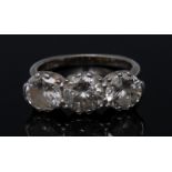 A diamond trilogy ring, each round brilliant cut diamond approx 1ct,