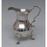 A George II silver cream jug, wavy rim, acanthus capped double scroll handle, shaped pad feet,