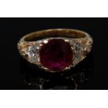 A ruby and diamond ring, central round fire red ruby, approx 3.