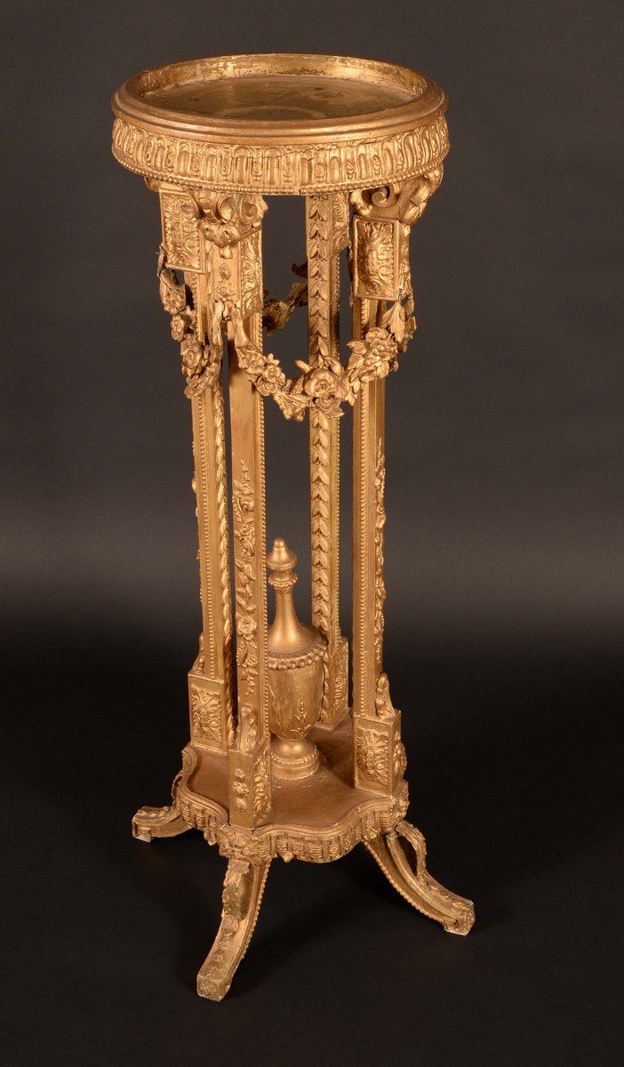 A 19th century giltwood jardiniere pedestal, the circular top above flowering swags,
