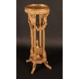 A 19th century giltwood jardiniere pedestal, the circular top above flowering swags,