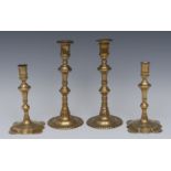 A pair of George II brass table candlesticks, of seamed construction, knopped stems,