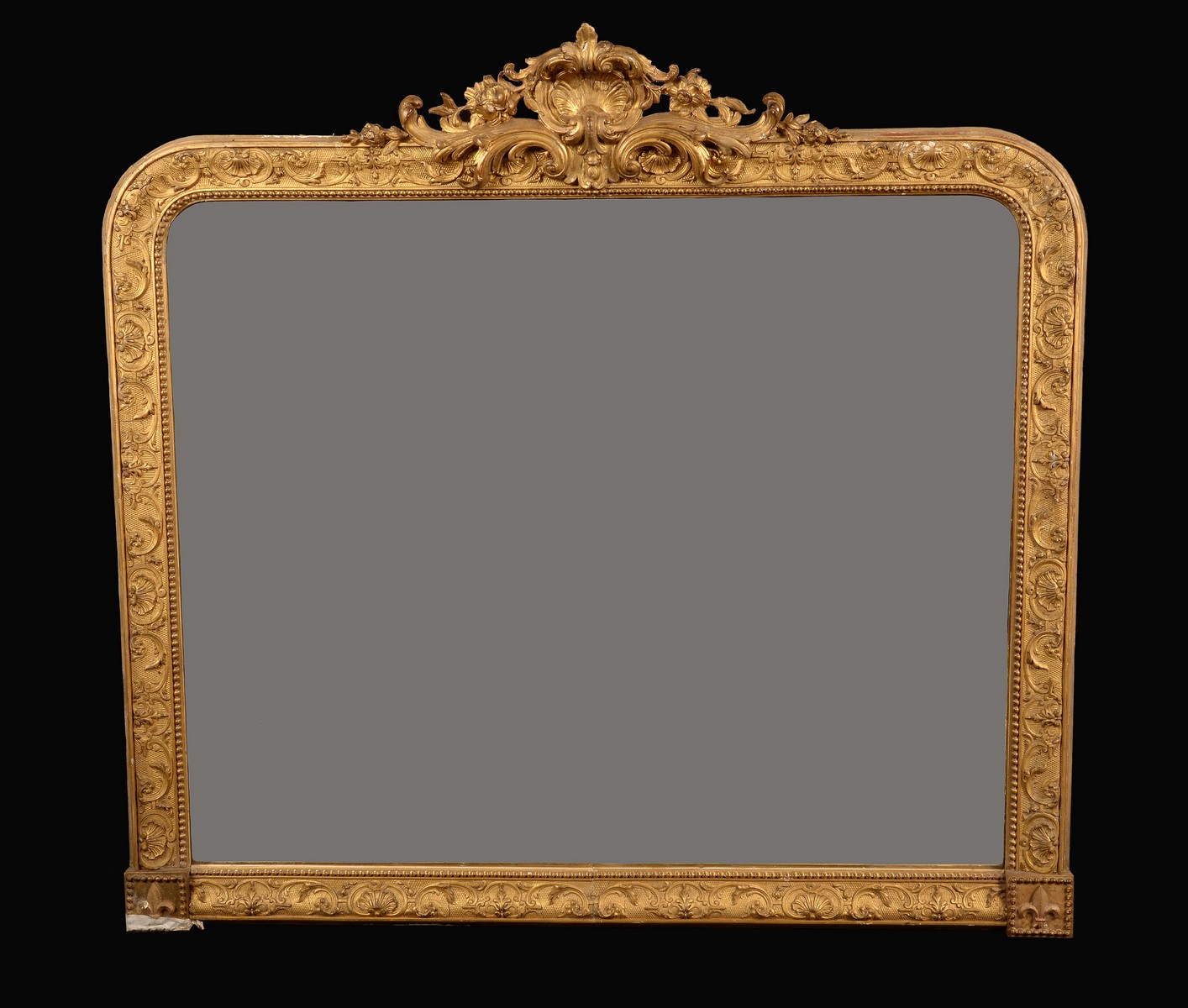 A 19th century giltwood and gesso rounded rectangular over mantel looking glass,